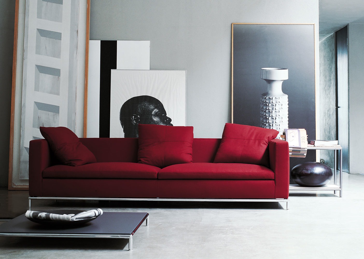 Sofa on a frame of steel upholstered in leather or fabric George