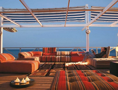 The sofa is modular, Voyage Immobile - Roche Bobois