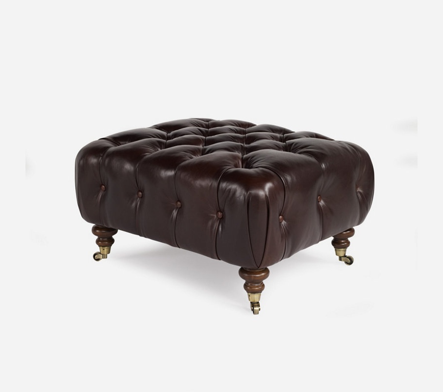 Leather Ottoman with wooden carved legs 
